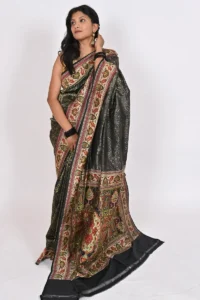 Embrace timeless beauty with our black Katan silk saree, featuring intricate all over zari work, a stunning designer meenakari border, and a magnificent pallu. Perfect for formal events or special occasions.